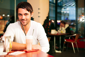 Good-looking Single Guy Sitting In A Cafe