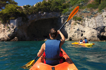 Girl is kayaking on the adriatic sea