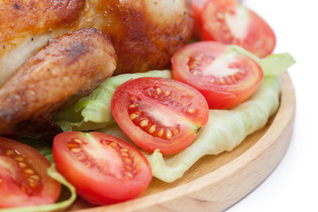 close up roast chicken on wooden plate  isolated on white