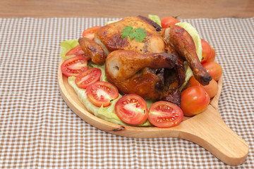  roast chicken on wooden plate