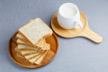 Whole Wheat Bread and milk on gray cloth