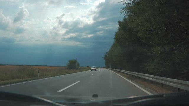 Car driving plate pov time lapse shot on cloudy summer day