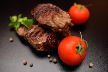 Steak from beef sous vide closeup on a dark background