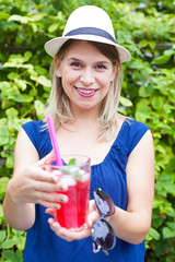 Fototapeta premium Happy woman with raspberry mint lemonade outdoor
