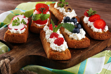 Bread Brushetta or authentic traditional spanish tapas set for lunch table. Sharing antipasti on party or summer picnic time over wooden rustic background.
