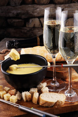 Gourmet Swiss fondue dinner on a winter evening with assorted ch