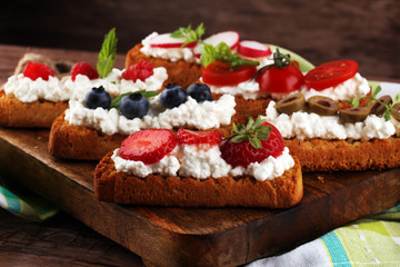 Bread Brushetta or authentic traditional spanish tapas set for lunch table. Sharing antipasti on party or summer picnic time over wooden rustic background.