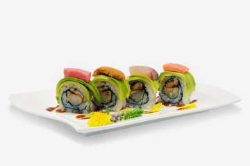 Avocado sushi rolls in white plate japanese style on white background
