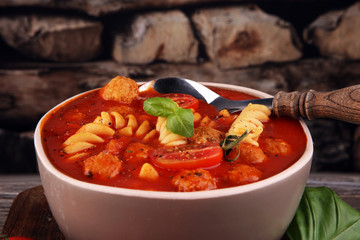 Tomato soup with meatballs in a bowl. Italian minestrone soup