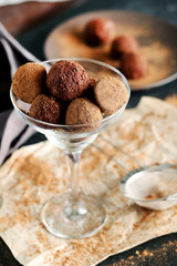 Sweet chocolate truffle on a black wooden table