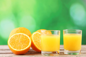 Glass of orange juice on wooden table