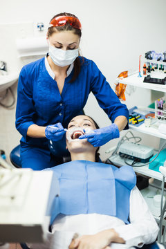 Dentist holding tooth whitening procedure