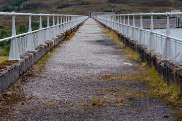 Walking path on top of hydroelectric dam wall in Scotland
