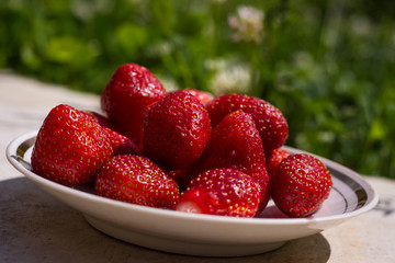 Red fruit strawberries on a plate