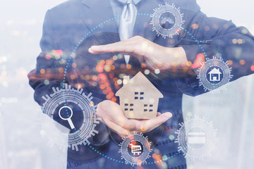 Double exposure,Business man holding house representing home ownership and the Real Estate business, money and stack of coins,interface smart home assistant on a virtual screen for buying new house