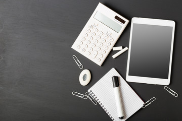 Tablet pc, notebook stack and pencils. Schoolchild and student studies accessories. Back to school concept.