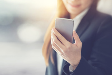 Close up of a business woman using mobile smart phone, copy space.