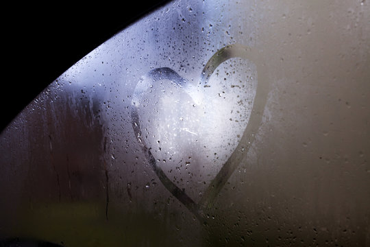 Love sign in the glass of a car