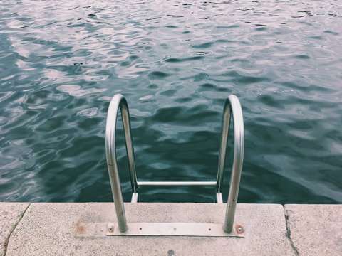 Pool ladder leading into the water