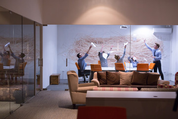 Group of young business people throwing documents