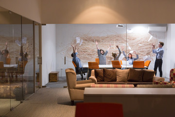 Group of young business people throwing documents