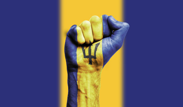 Barbados flag painted on a clenched fist. Strength, Power, Protest concept