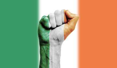 Ireland flag painted on a clenched fist. Strength, Power, Protest concept