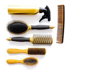 Combs and hairdresser tools in beauty salon on white background top view copyspace