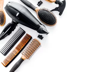 Wall murals Beauty salon Combs and hairdresser tools in beauty salon on white background top view copyspace