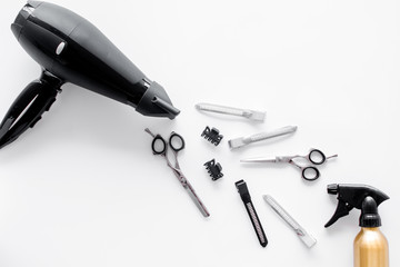 Hairdryer and hairdresser tools in beauty salon on white background top view copyspace