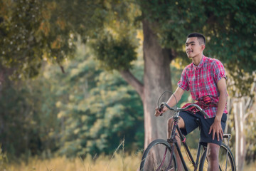 Asian men wear traditional dresses  with old bikes.
