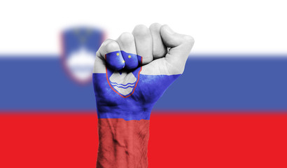 Slovenia flag painted on a clenched fist. Strength, Power, Protest concept