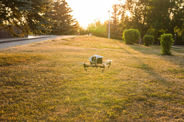White drone, quadrocopter with photo camera flying