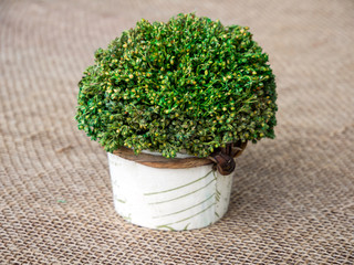 Decorative artificial flower on a background of sacking