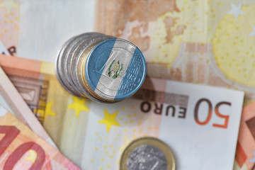 euro coin with national flag of guatemala on the euro money banknotes background.