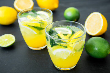 Fresh citrus lemonade made of limes, lemons and mint in glasses