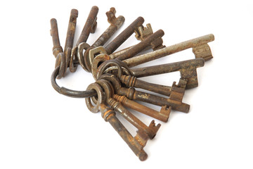 bunch of old rusty keys on white background