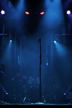 Microphone on stage with creepy lights behind