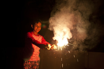 A teenage girl making fun with firecrackers