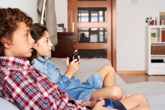 Kids playing videogame at home