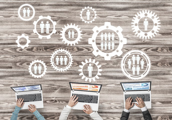 Top view of businesspeople sitting at table and using gadgets