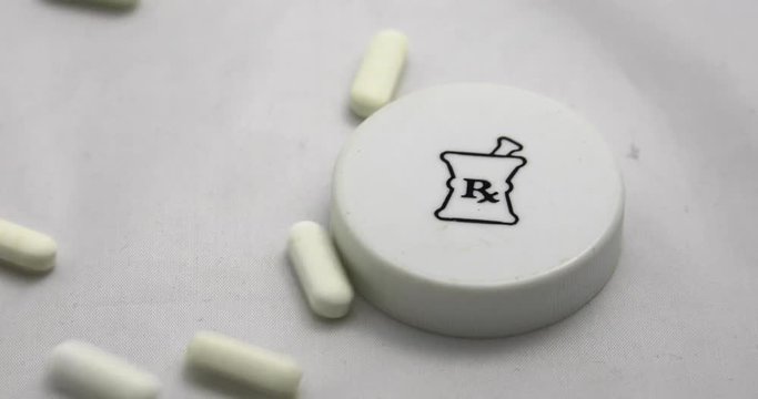 Pills falling on vial lid, 4K