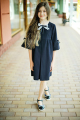 Obraz premium Kid girl in school uniform