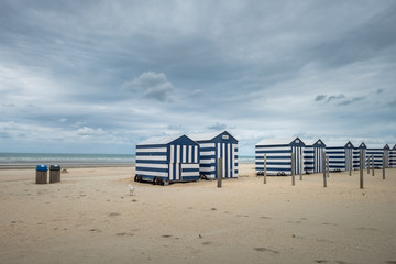 Row of colorful beach cabins on a cloudy day
