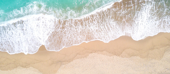 Aerial view of sandy beach and ocean with waves