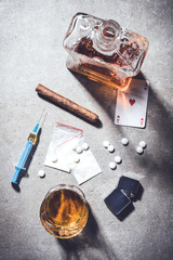 Hard drugs and alcohol on gray stone table. Top view