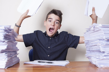 child student on the desk with stacked papers