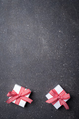 Small gift boxes on gray stone background. Close up