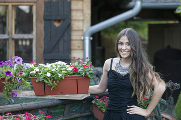 Young beautiful woman in dress standing in the park