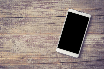 Modern smart phone on an old wooden background